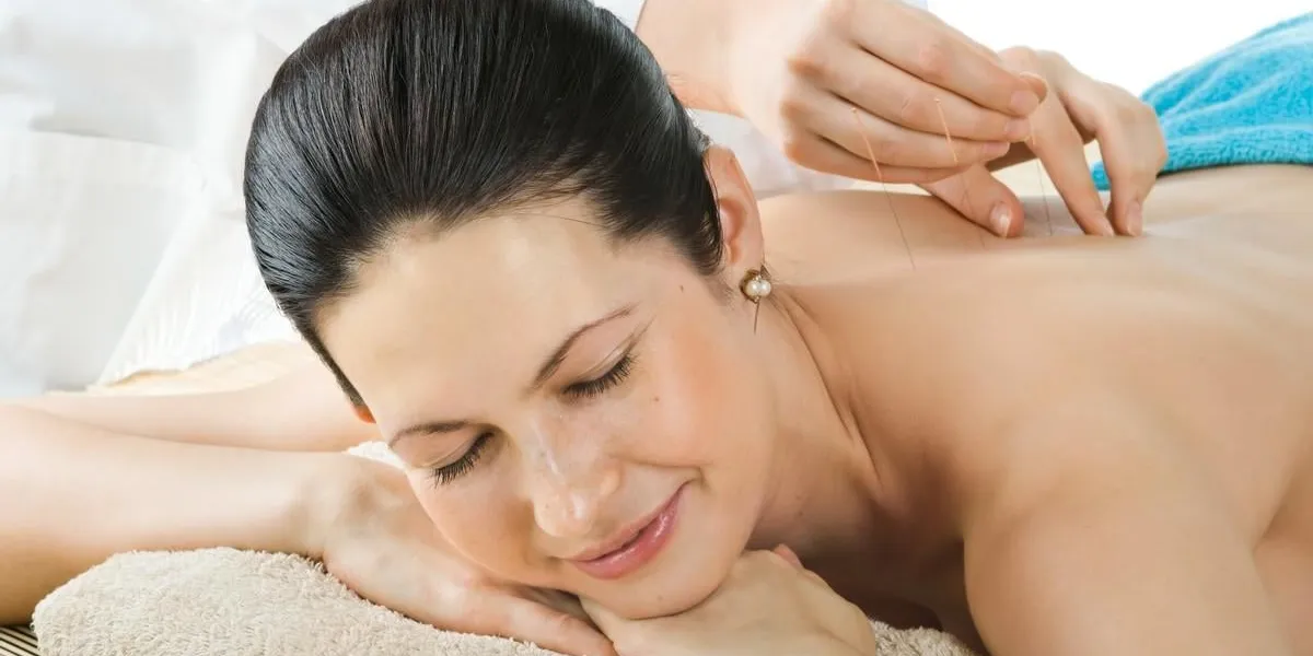 the very pretty young woman on acupuncture treatment , horizontal portrait