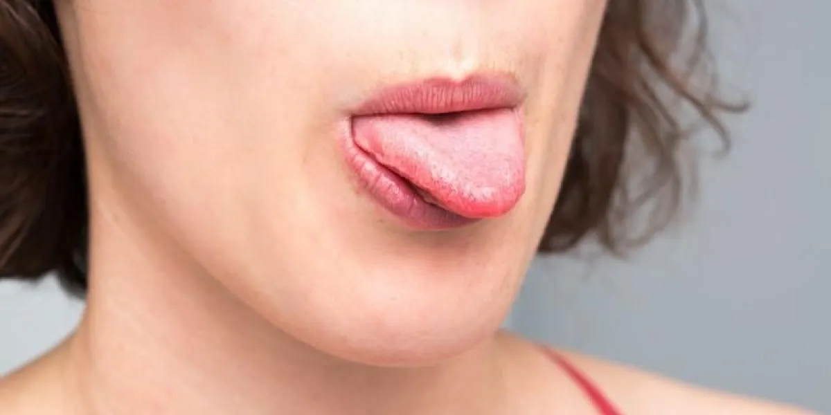 woman showing the tip of the tongue
