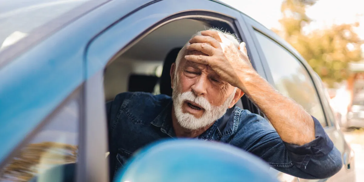 aggressive man driving car shouting at someone angry old man stuck in a traffic jam man annoyed in car senior men stuck in traffic