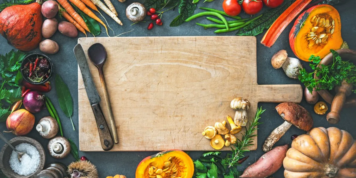 traditional autumn vegetables ingredients for tasty thanksgiving or christmas dishes on rustic kitchen table top view