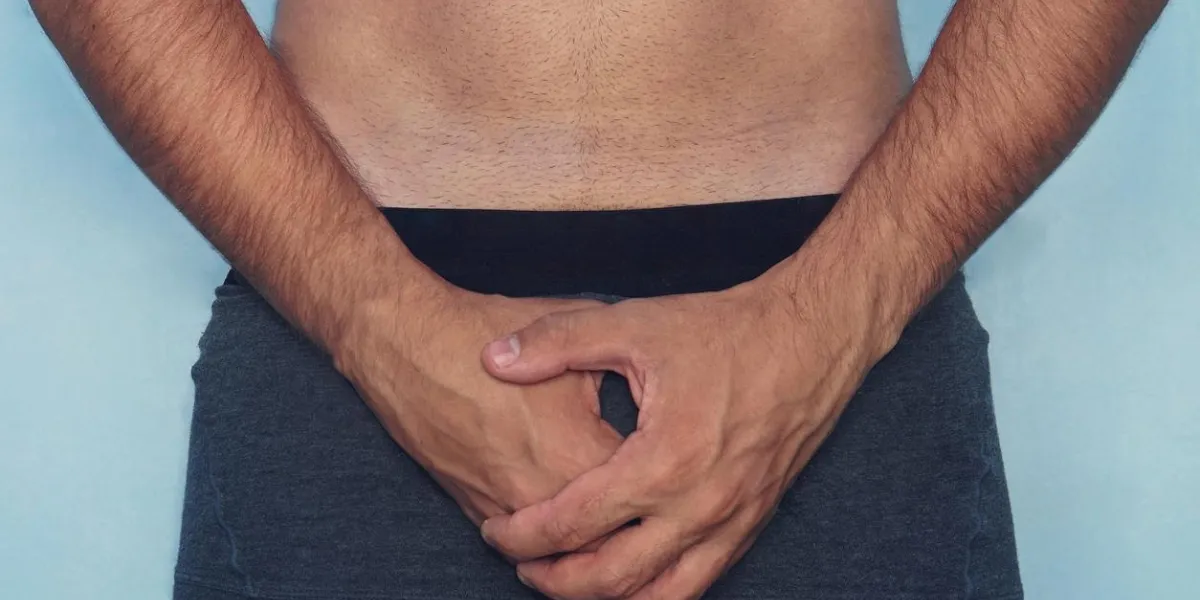 handsome man is using his hands closing his penis attractive man gets painful of mind, he can t has sex he get erectile dysfunction he feels unhappy and depressed he feels shy and lost confident