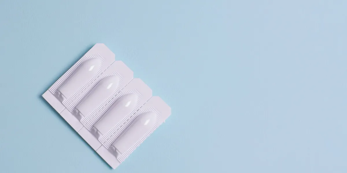 suppository for anal or vaginal use on a blue background candles for treatment of hemorrhoids, temperature, thrush, inflammation