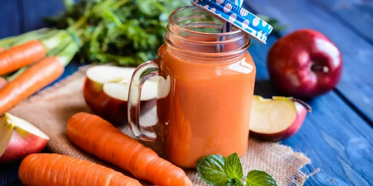 fresh carrot and apple smoothie in a glass jar