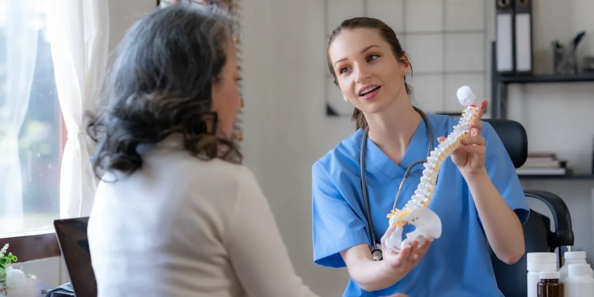 female doctor is introducing an elderly asian female patient about bone diseases and treatment method and medicine details