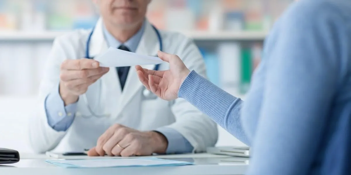 doctor in his office giving a medical prescription to the patient, healthcare concept