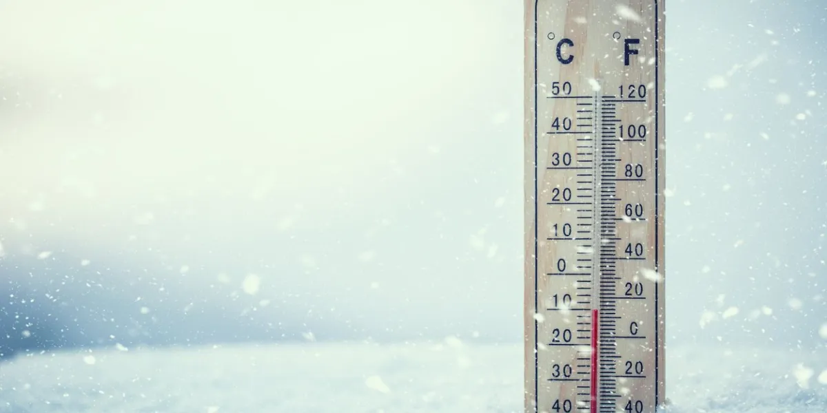 thermometer on snow shows low temperatures under zero low temperatures in degrees celsius and fahrenheit cold winter weather ten under zero