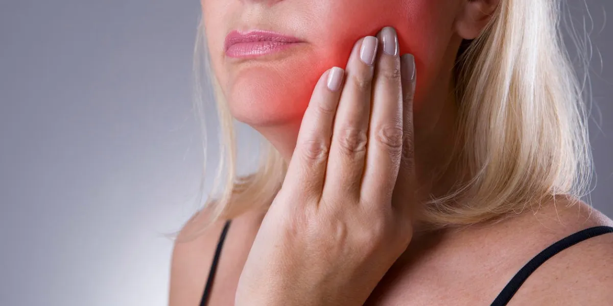 aged woman with toothache, teeth pain closeup with red spots