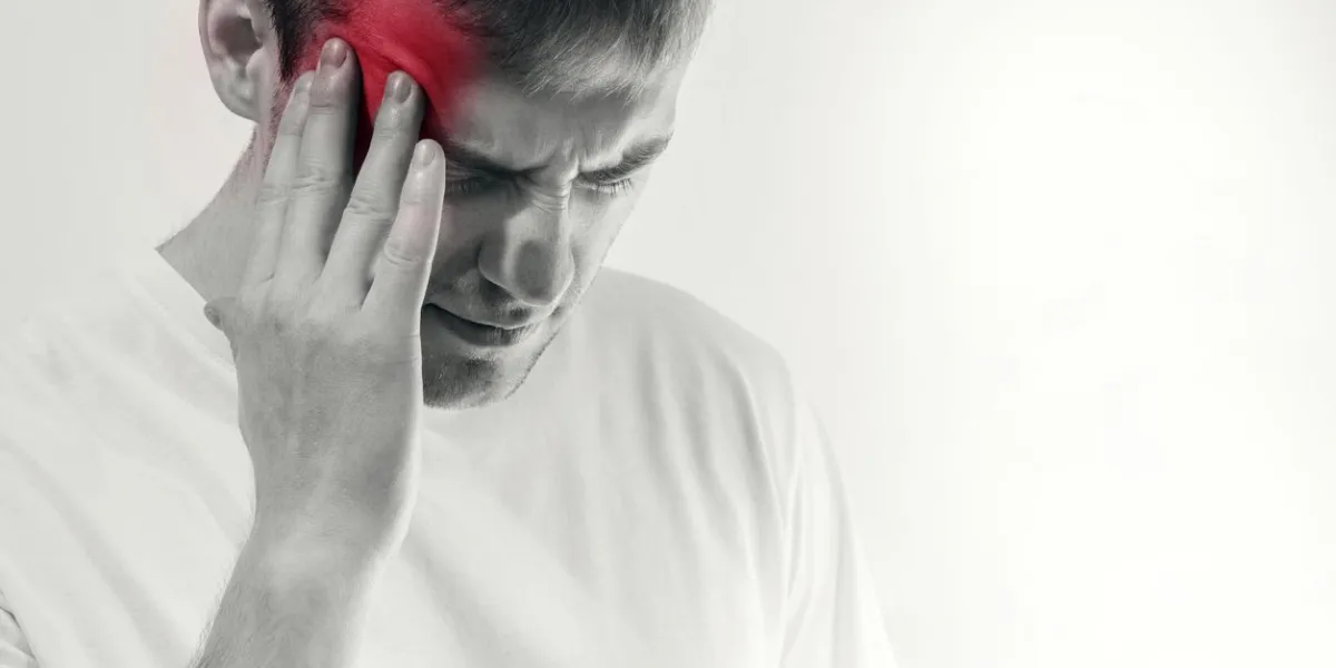 man hold his had and suffering from headache, pain, migraine, sad depressed isolated on white background, in a white t shirt