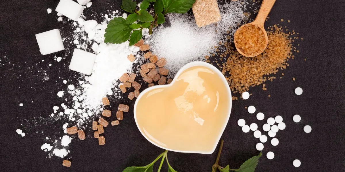various types of sugar from above - brown, white, crystal, cane, powdered sugar and artificial sweetener and honey in bowl aztec sweet herb
