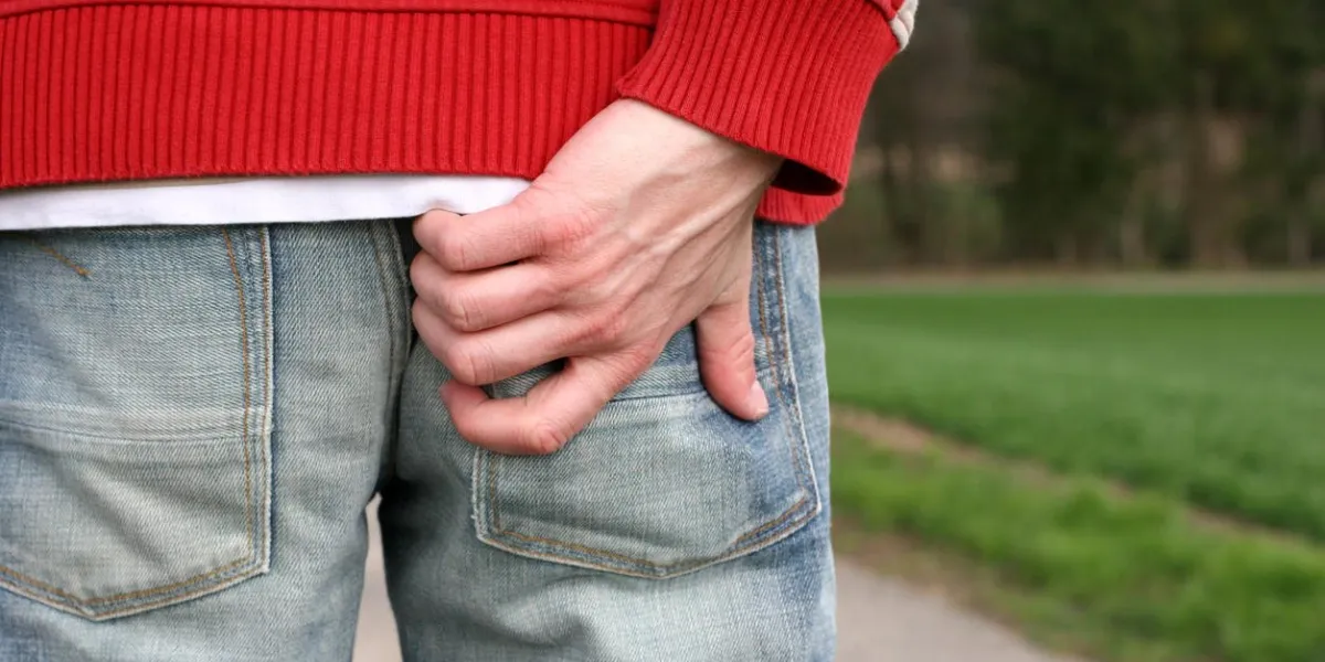 man scratch his bottom