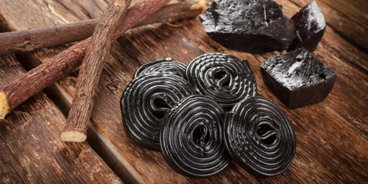 production steps of licorice, roots, pure blocks and candy on wooden table