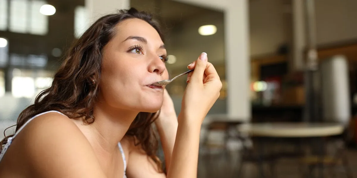 woman using spoon in a coffee shop