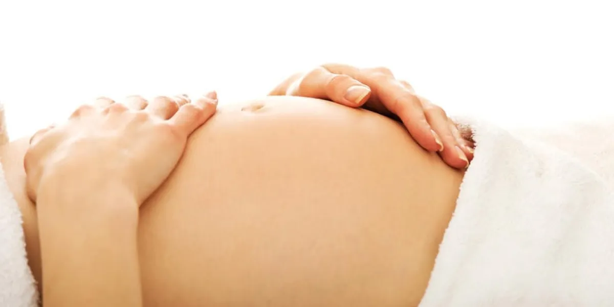femme enceinte massagin son ventre grandissant