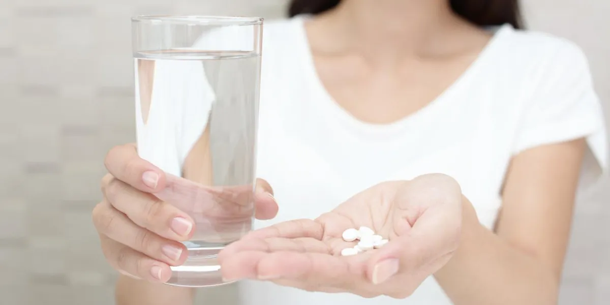 supplements in hand of woman