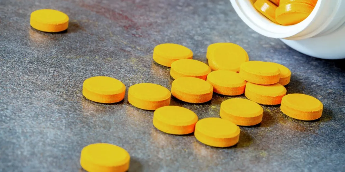 closeup on turmeric tablets, a natural food supplement with multiple virtues