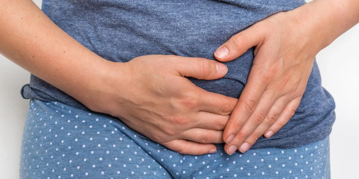 woman with menstrual pain is holding her aching belly - body pain concept