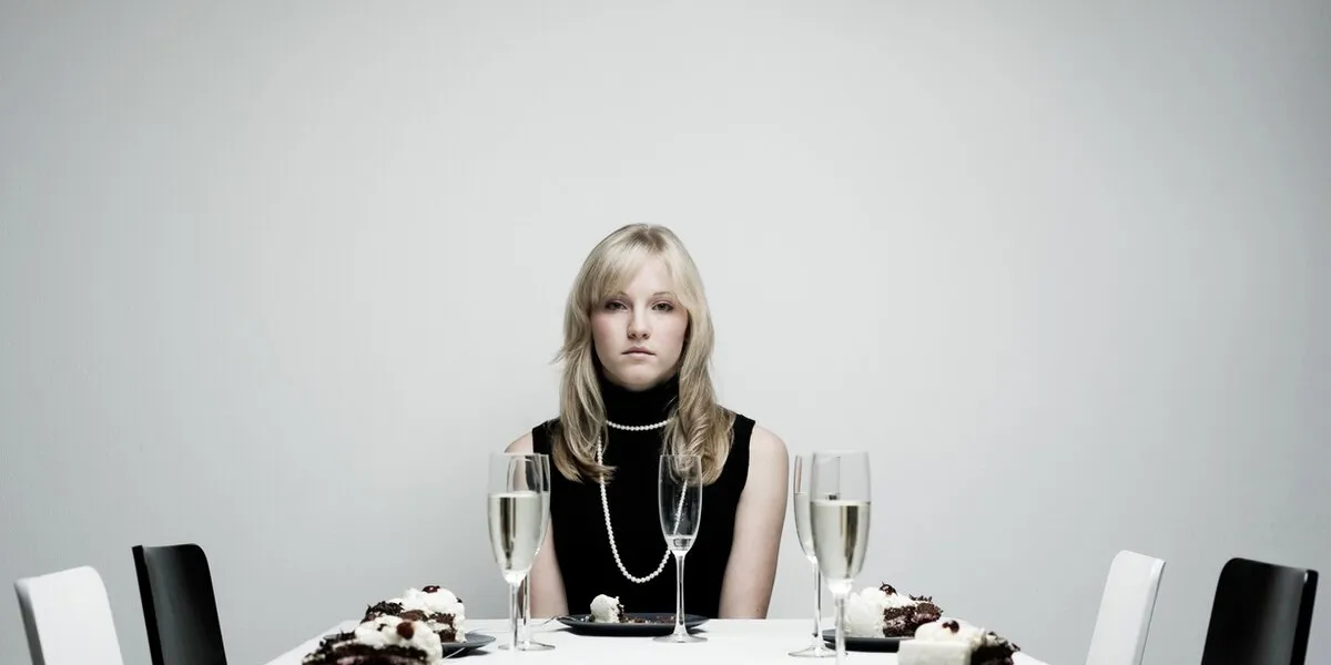 young woman sitting at empty by herself