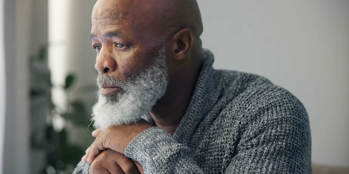 depression, sad and senior man at home with mourning and memory with mental health problem elderly male person, sorry and anxiety in a house feeling disappointed in retirement with grief and fail