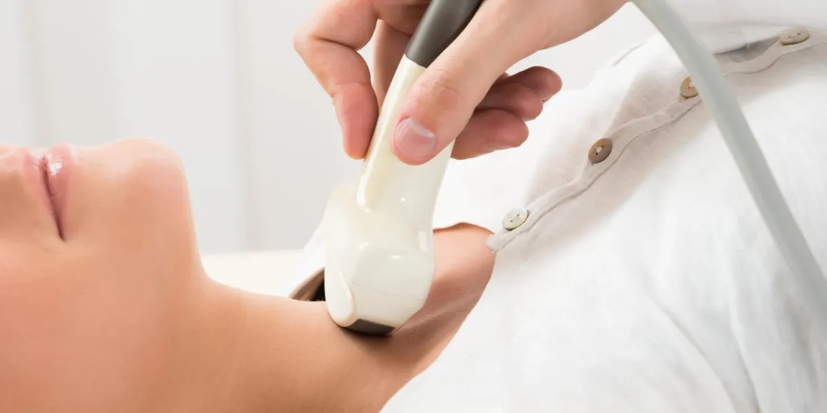 young woman doing neck ultrasound examination at hospital