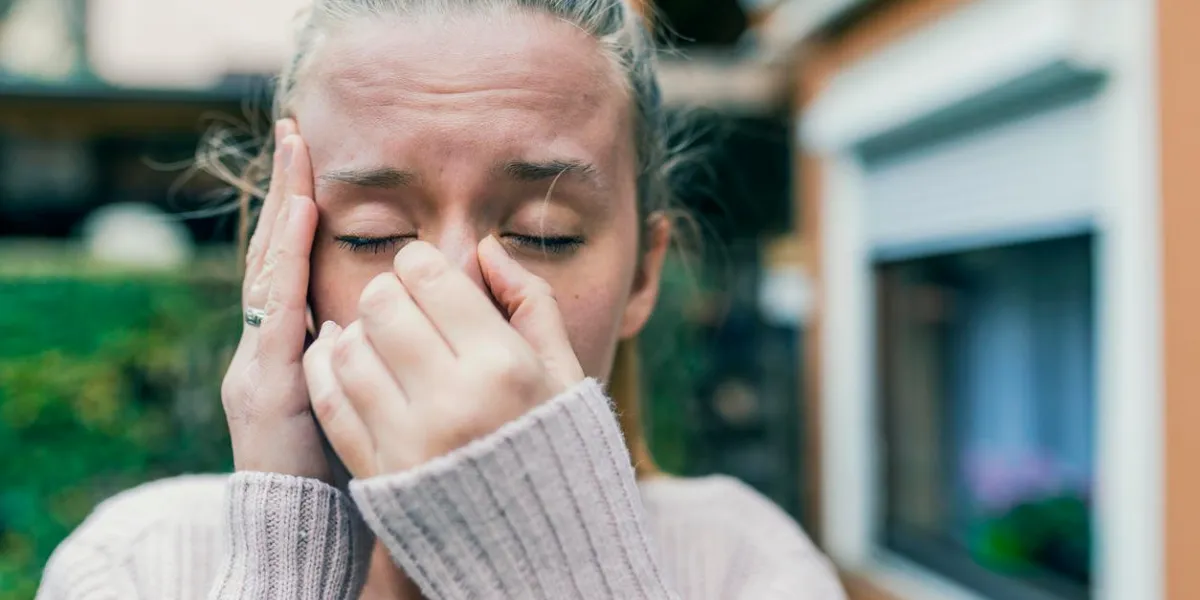 sinus ache causing very paintful headache unhealthy woman in pain sharp strong sore sinus pain, sinus pressure, sinusitis sad woman holding her nose and head because sinus pain