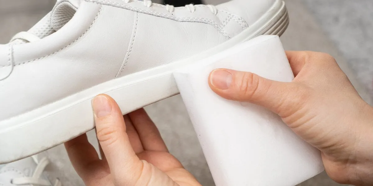 cleaning white shoes and soles from dust and dirt with a melamine sponge