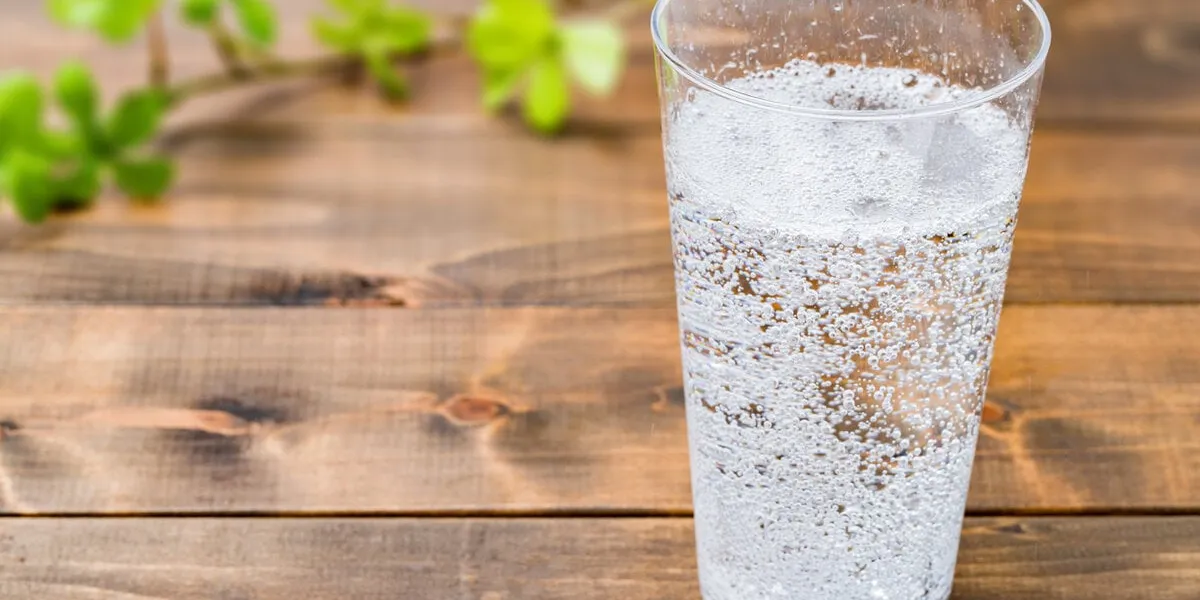 carbonated water on wood grain background