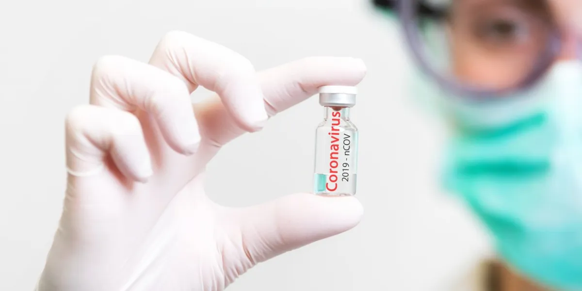 a doctor in medical gloves and mask holding an ampula with vaccine close up shot coronavirus, epidemic and medicine concept