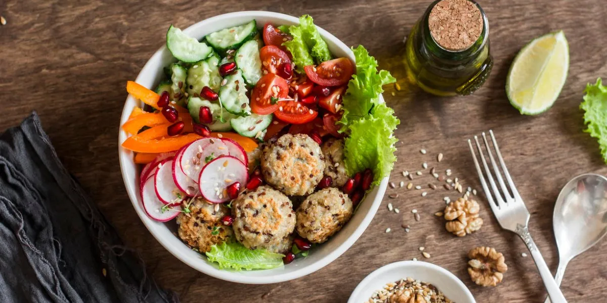 boulettes de viande de quinoa au four et salade de légumes sur une table en bois, vue supérieure bol de bouddha en bonne santé, alimentation, notion de plats végétariens