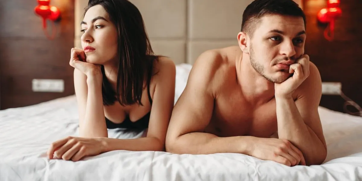 love couple lies in bed, no sexual desire problems in intimate life, impotence, anxiety or depression