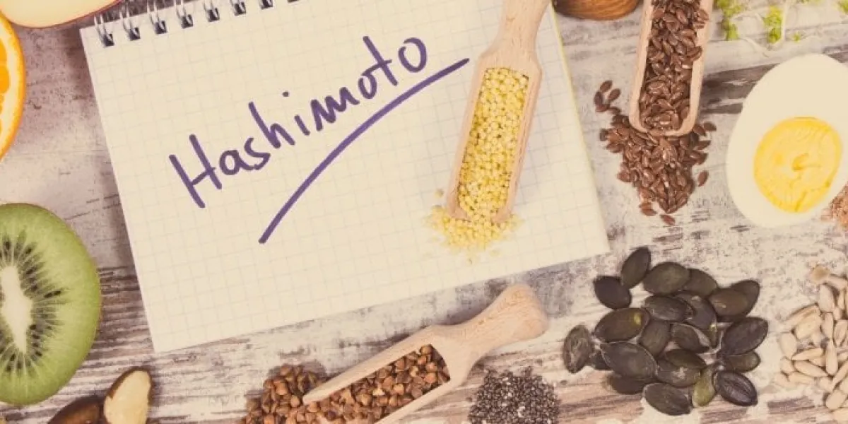 notepad with inscription hashimoto and best ingredients or products for healthy thyroid food containing natural minerals and vitamins