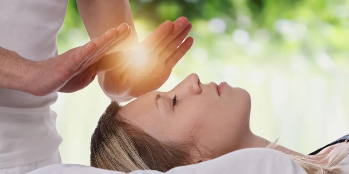 woman having reiki healing treatment , alternative medicine concept