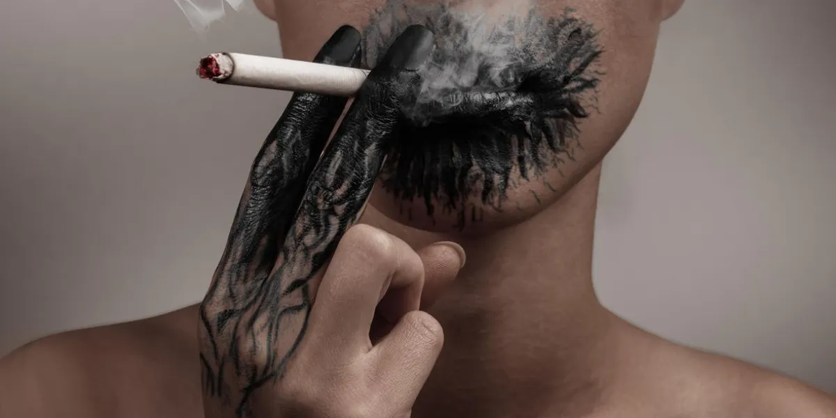 woman smokes a cigarette, her hand and her mouth blackened, concept of a slow death from smoking