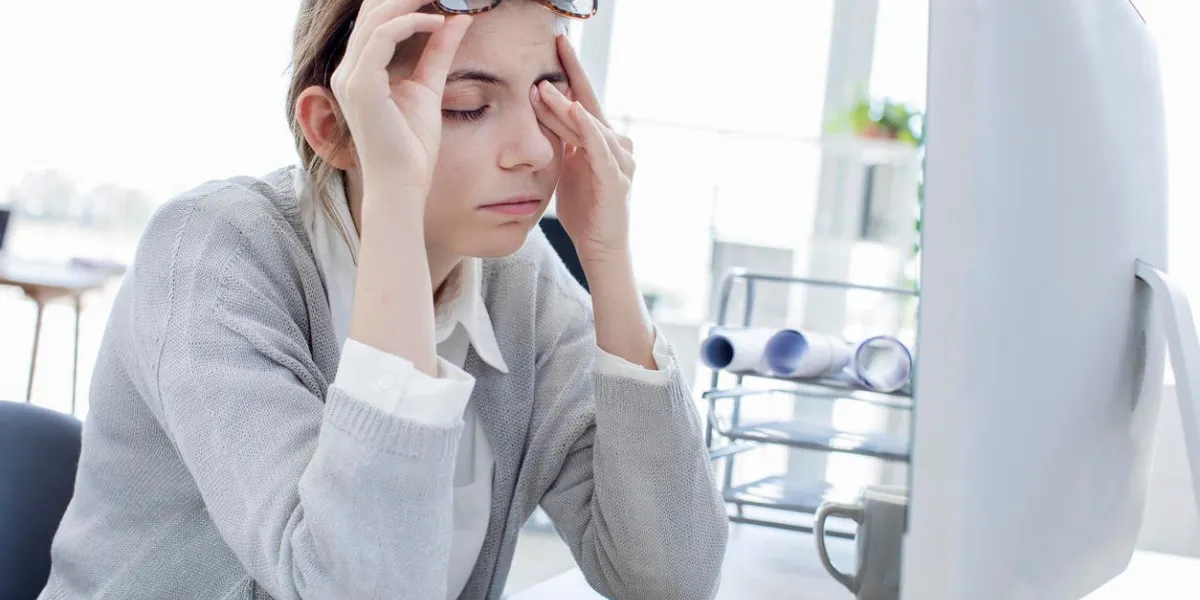 tired woman touching her eyes