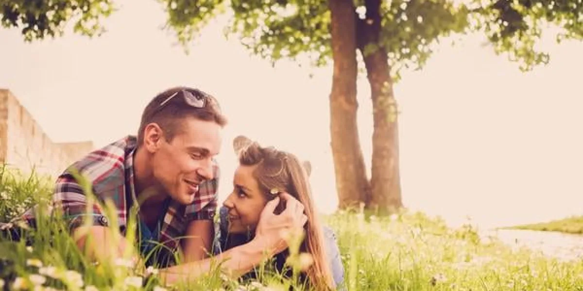 heureux jeune couple allongé sur l'herbe