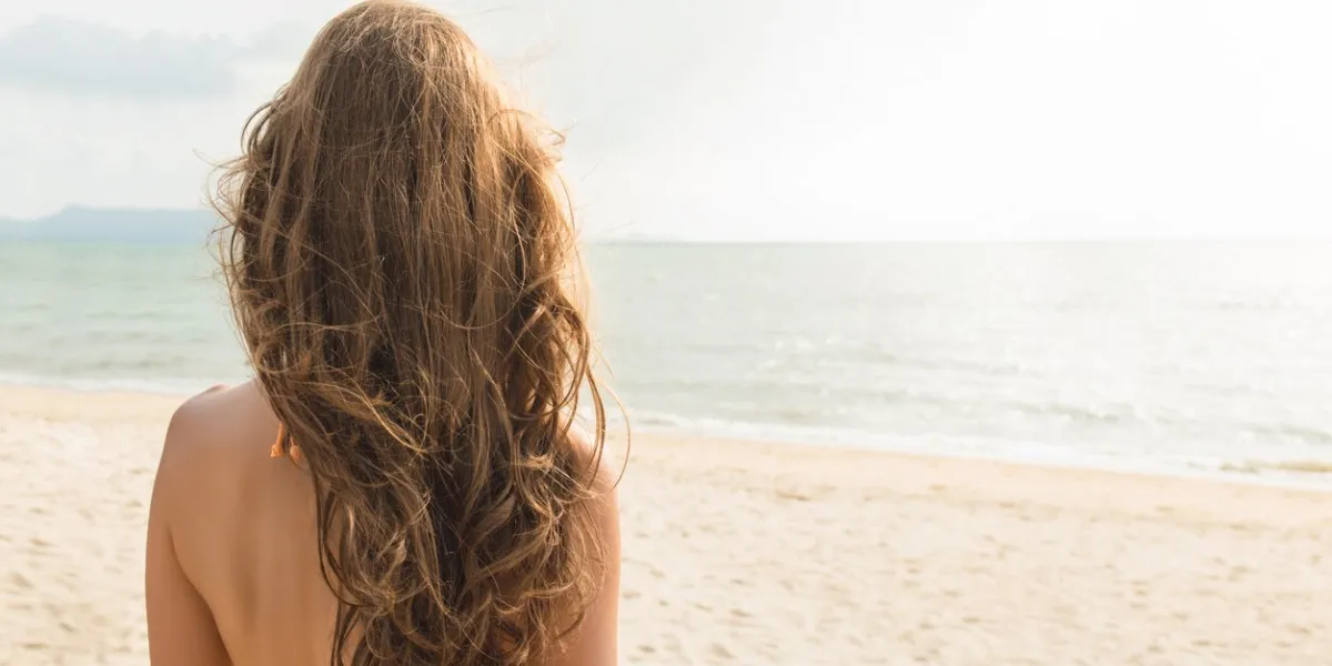 beautiful independent woman looking at the view in tropical beach during summer vacations