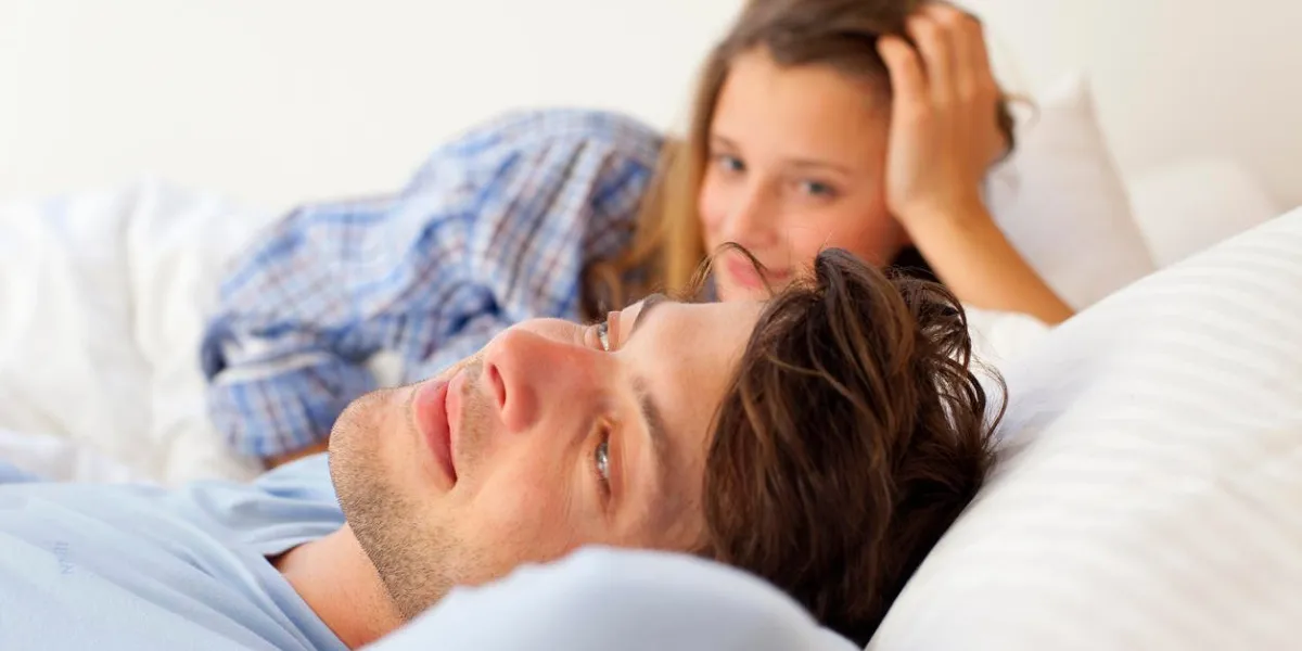 smiling couple relaxing in bed