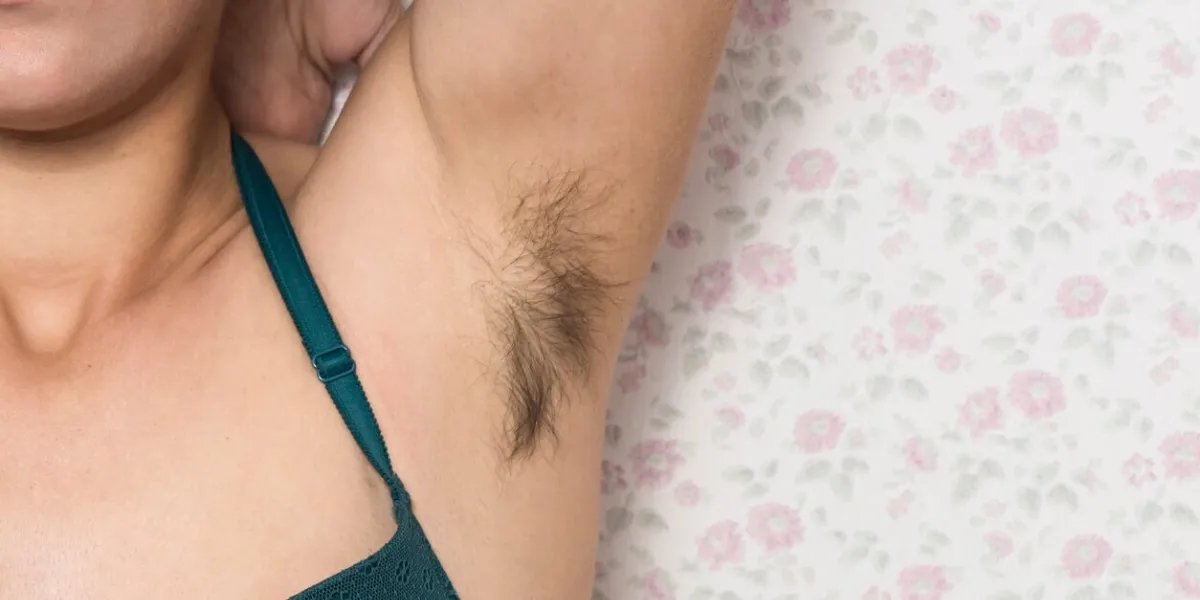 hairy woman's armpit woman without waxing unplucked hair woman showing natural body hair without shaving hair growing in the armpit with the barazos without shaving self-confident girl