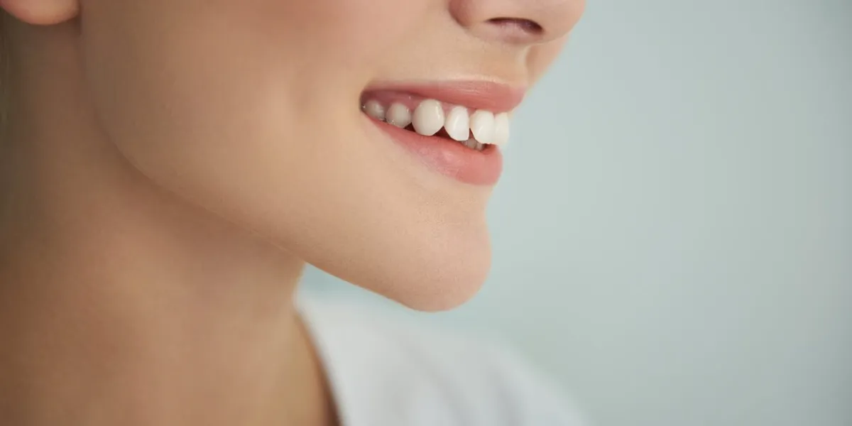 close up portrait of charming girl demonstrating her perfect white teeth