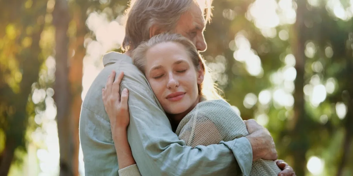 hugging lovingly in the park