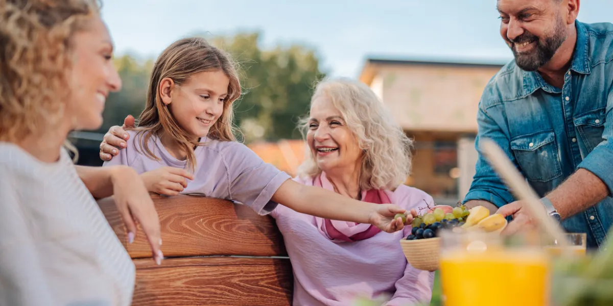 happy family enjoying a healthy meal together outdoors in the garden