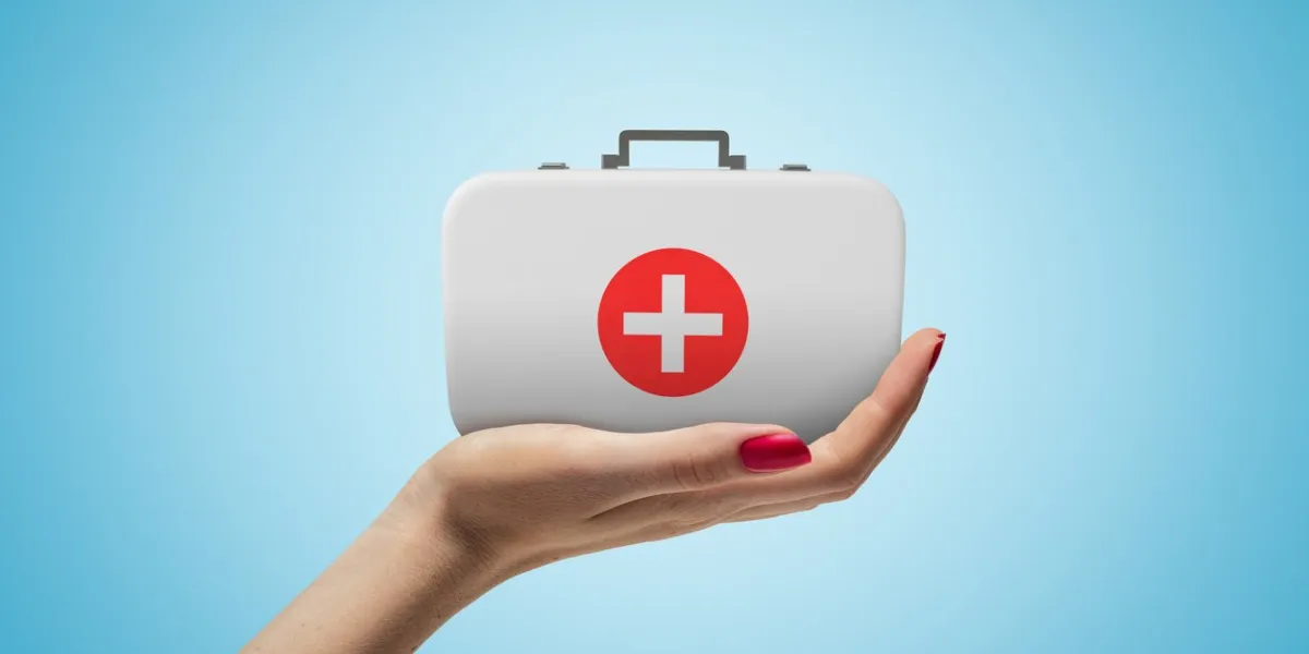 side closeup of woman's hand facing up and holding small medical bag on light blue gradient background healthcare first aid pharmaceutical business