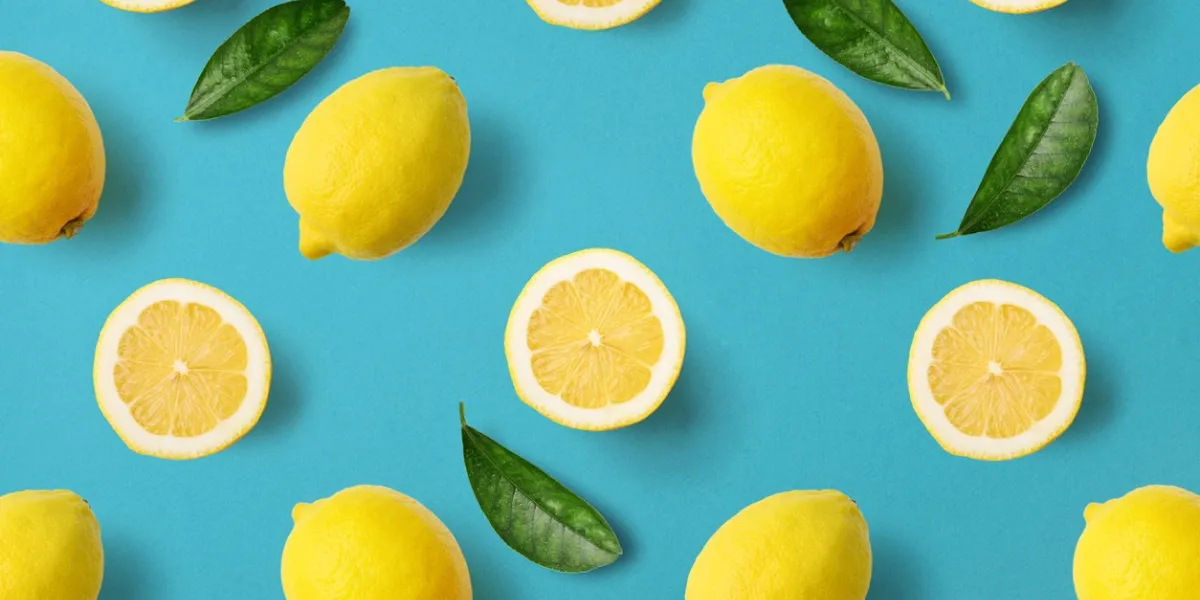 colorful fruit pattern of lemons on blue background, top view
