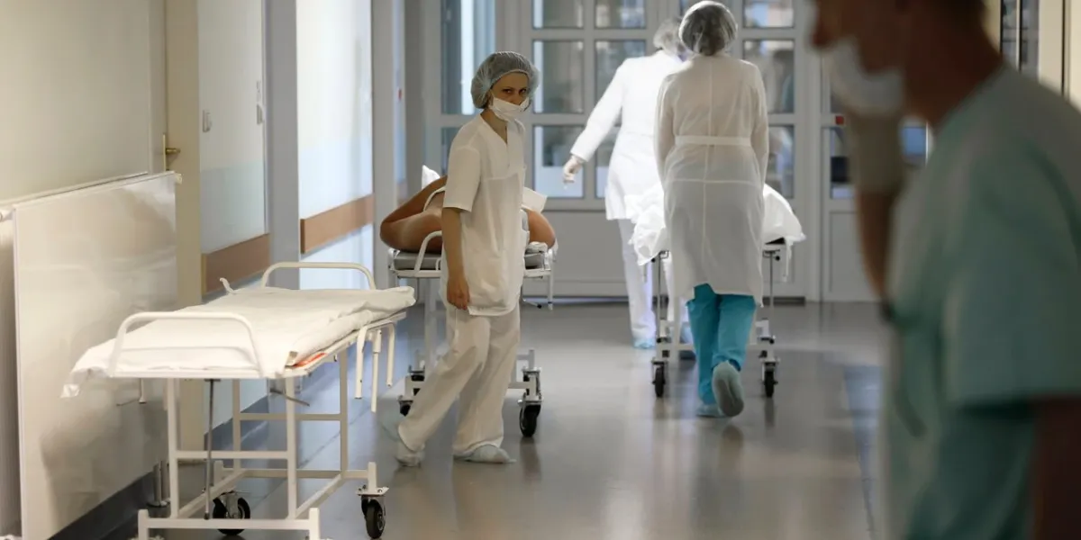 doctors in white coats carry the patient on a stretcher the real situation in the hospital
