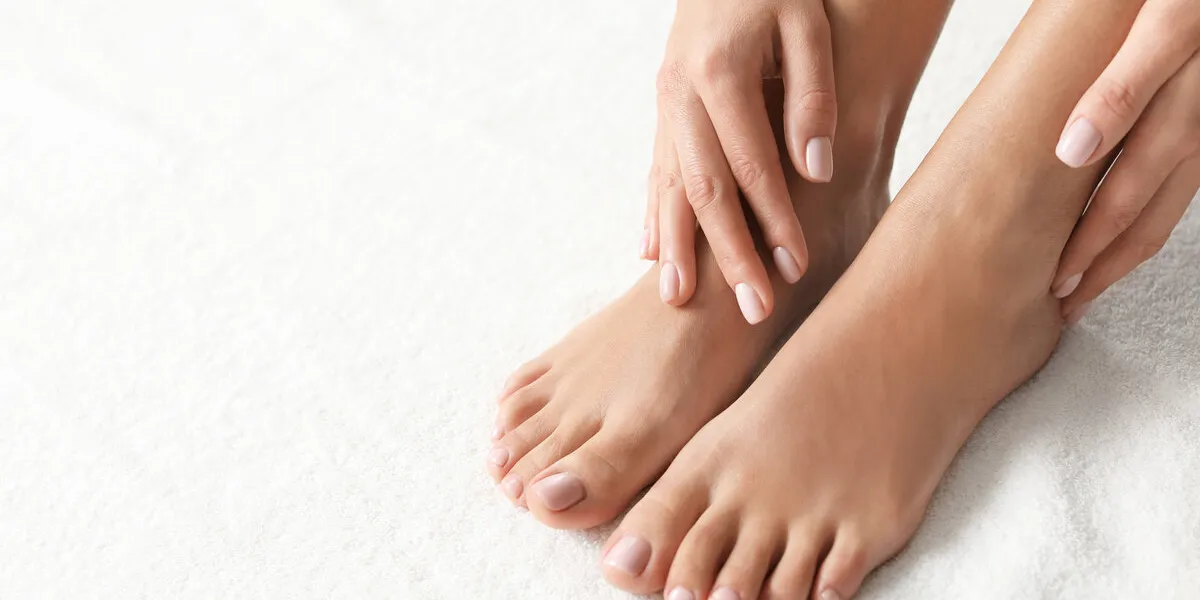 woman with beautiful feet on white towel, closeup spa treatment