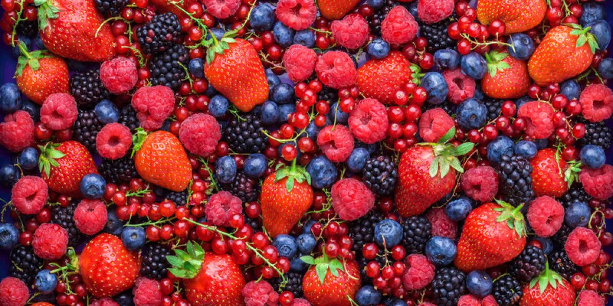 berries overhead closeup colorful assorted mix of strawbwerry, blueberry, raspberry, blackberry, red curant in studio on dark background