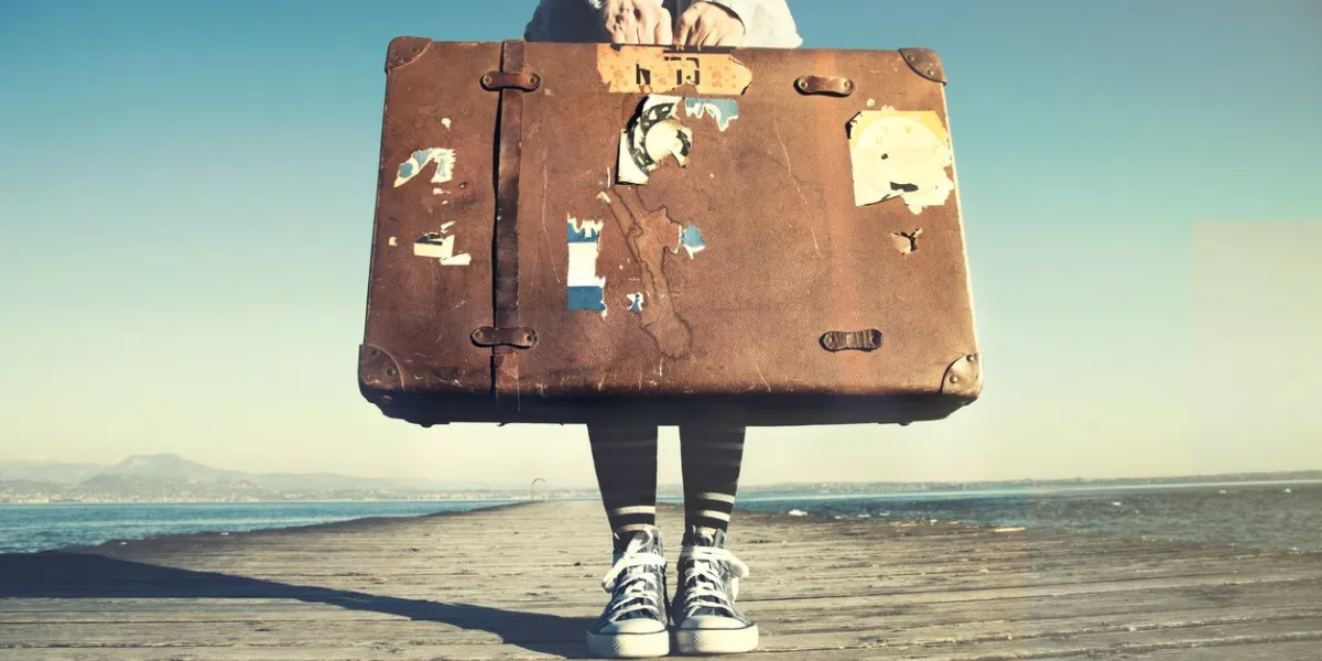 young woman ready to travel with her suitcase