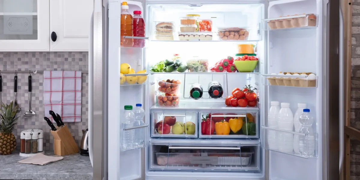 an open refrigerator filled with fresh fruits and vegetables