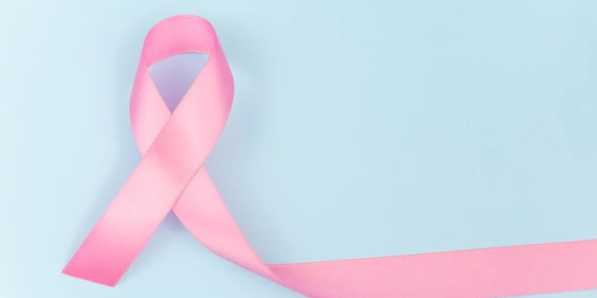 pink ribbon symbol for breast cancer awareness concept on blue background with copy space for text, logo or wordings insertion or decoration