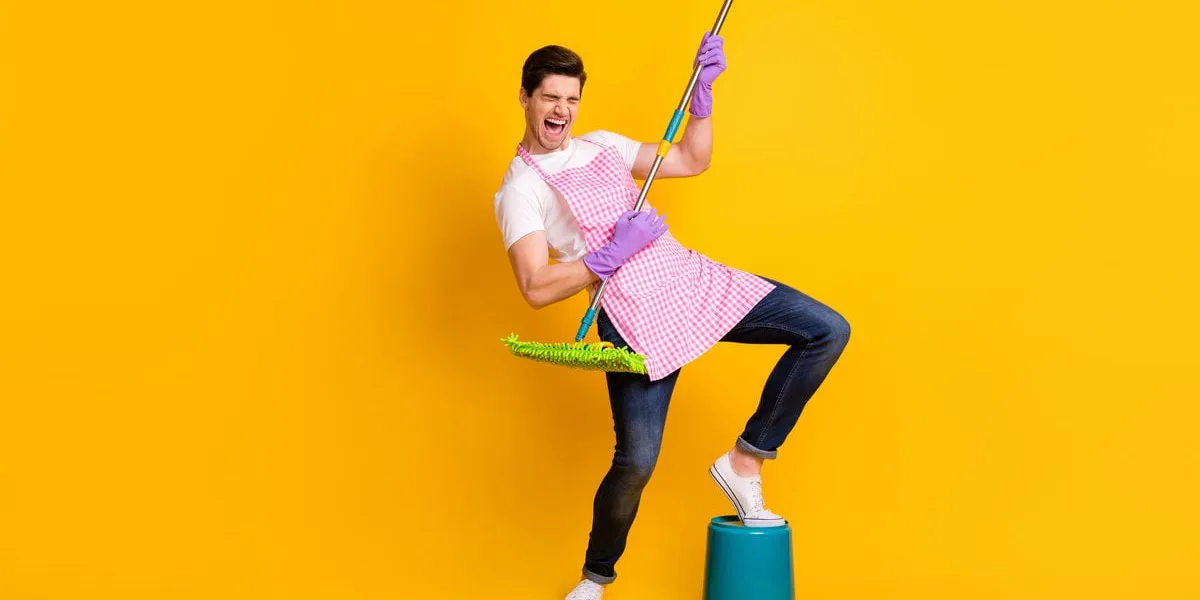 full size photo of young crazy screaming handsome man playing invisible guitar isolated on yellow color background