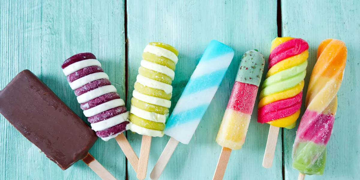 colorful popsicle ice cream on turquoise wooden background